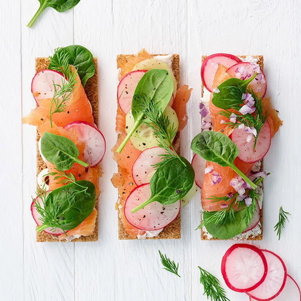 Lox, spinach, radish, and cucumber on bread