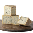 Load image into Gallery viewer, Three pieces of blue cheese on a wooden board with a white background
