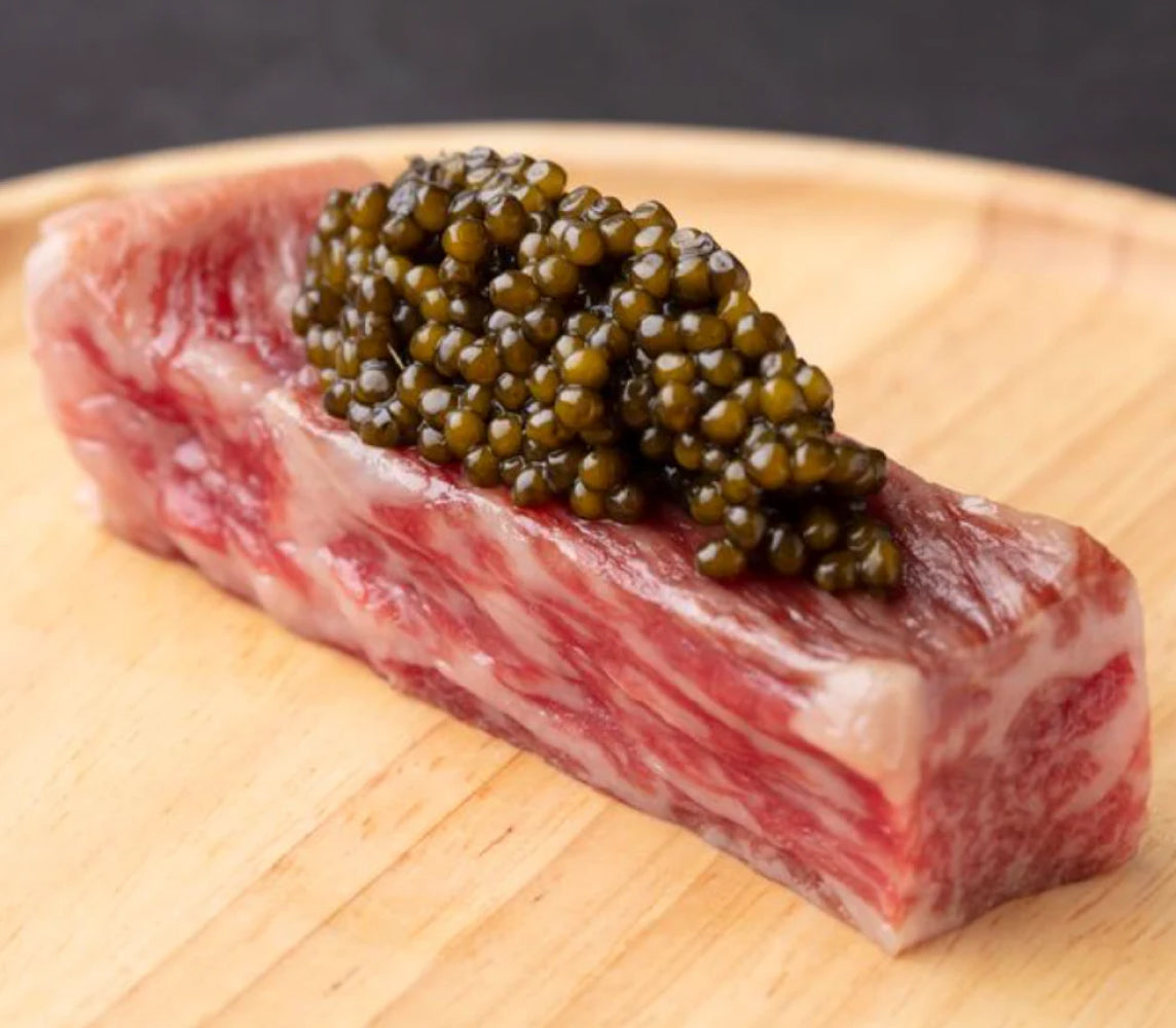 black caviar on a small piece of meat